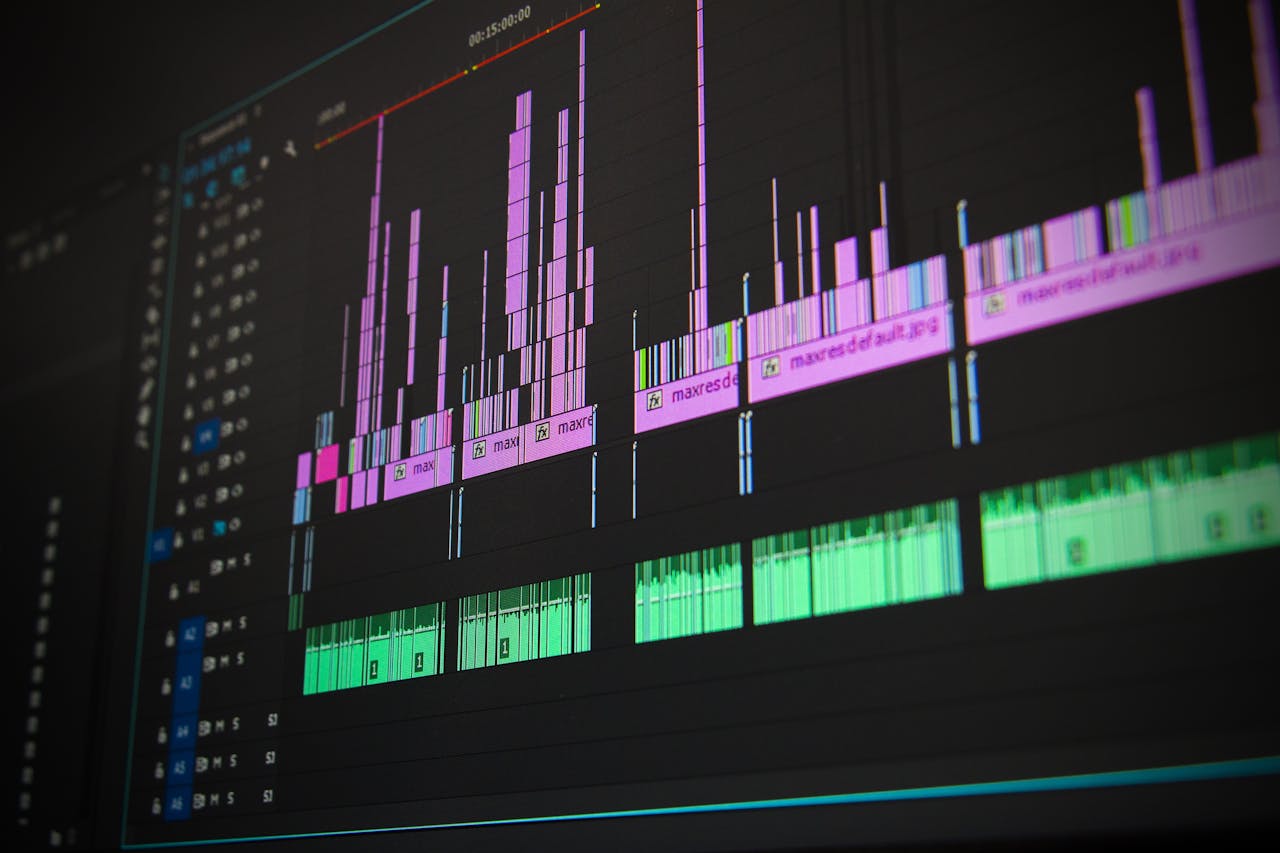 hero-img Close-up of a professional audio and video editing software interface with waveform displays.