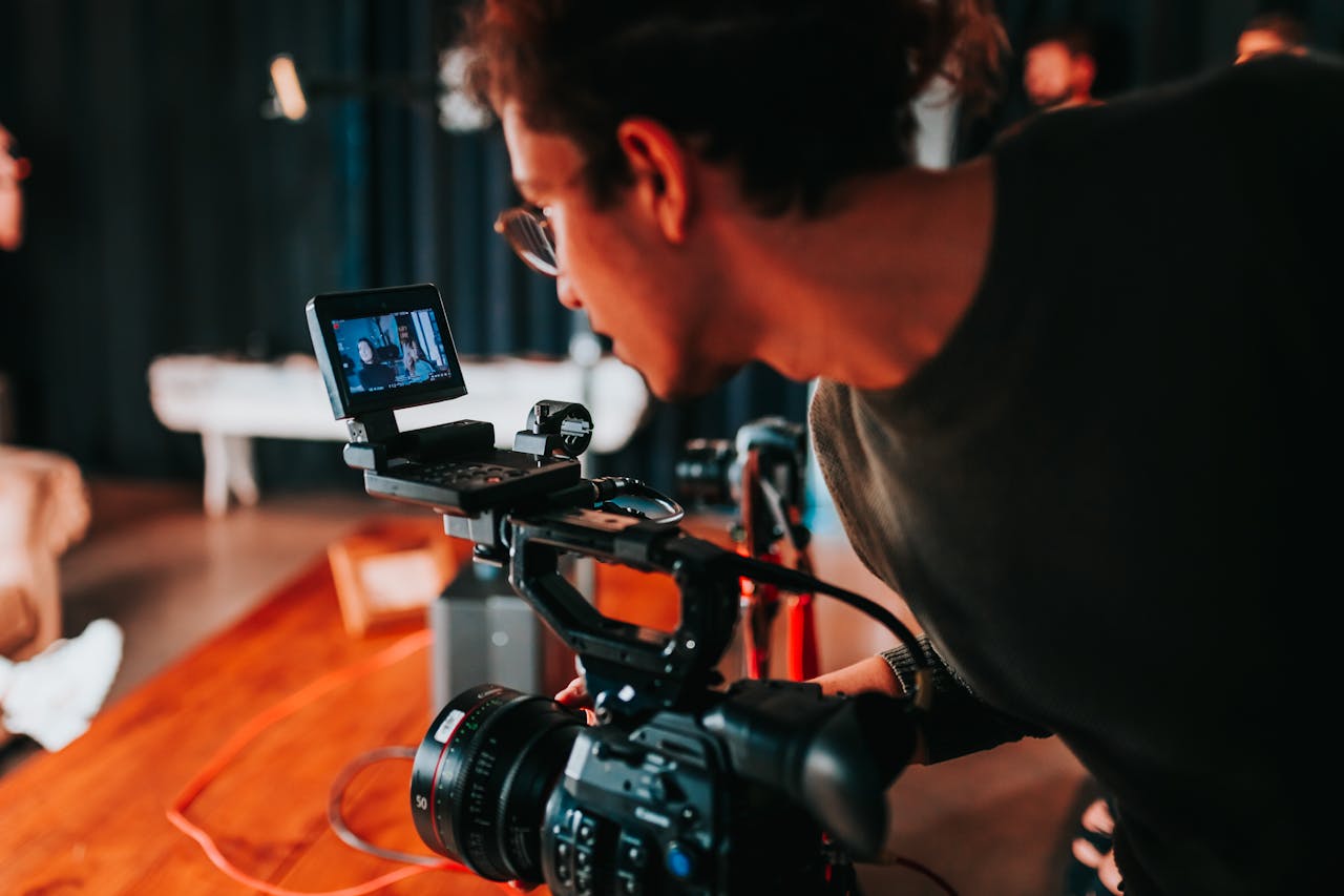 contact-img Man filming on set with professional video camera in studio setting.